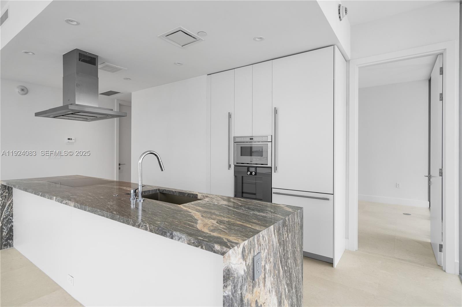 700 Northeast 26th Terrace, Unit 1406 Miami, FL 33137 - Photo 4 of 41 a kitchen with stainless steel appliances granite countertop a sink and a refrigerator