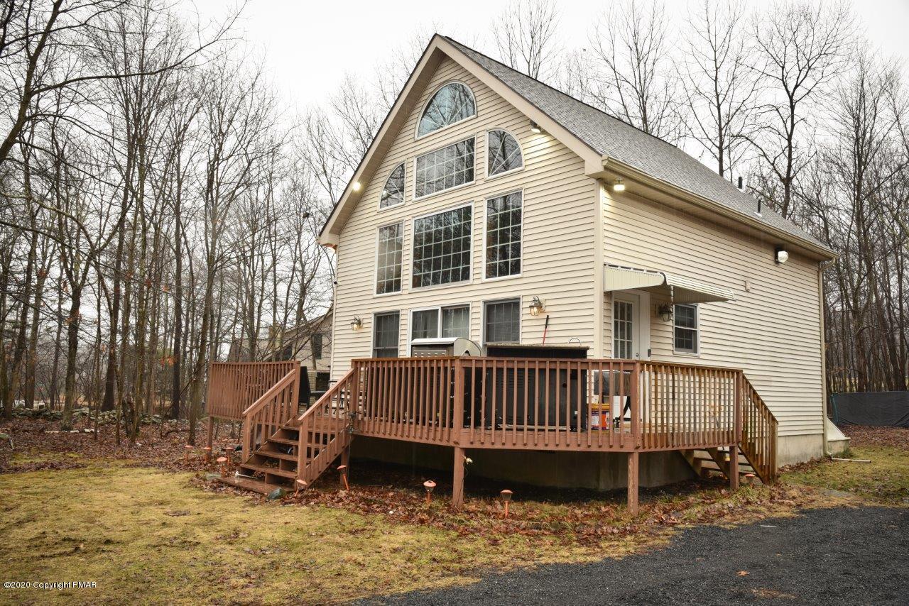 264 Kirkham Road Bushkill, PA 18324 - Photo 1 of 21 a view of a house with a yard and a wooden deck