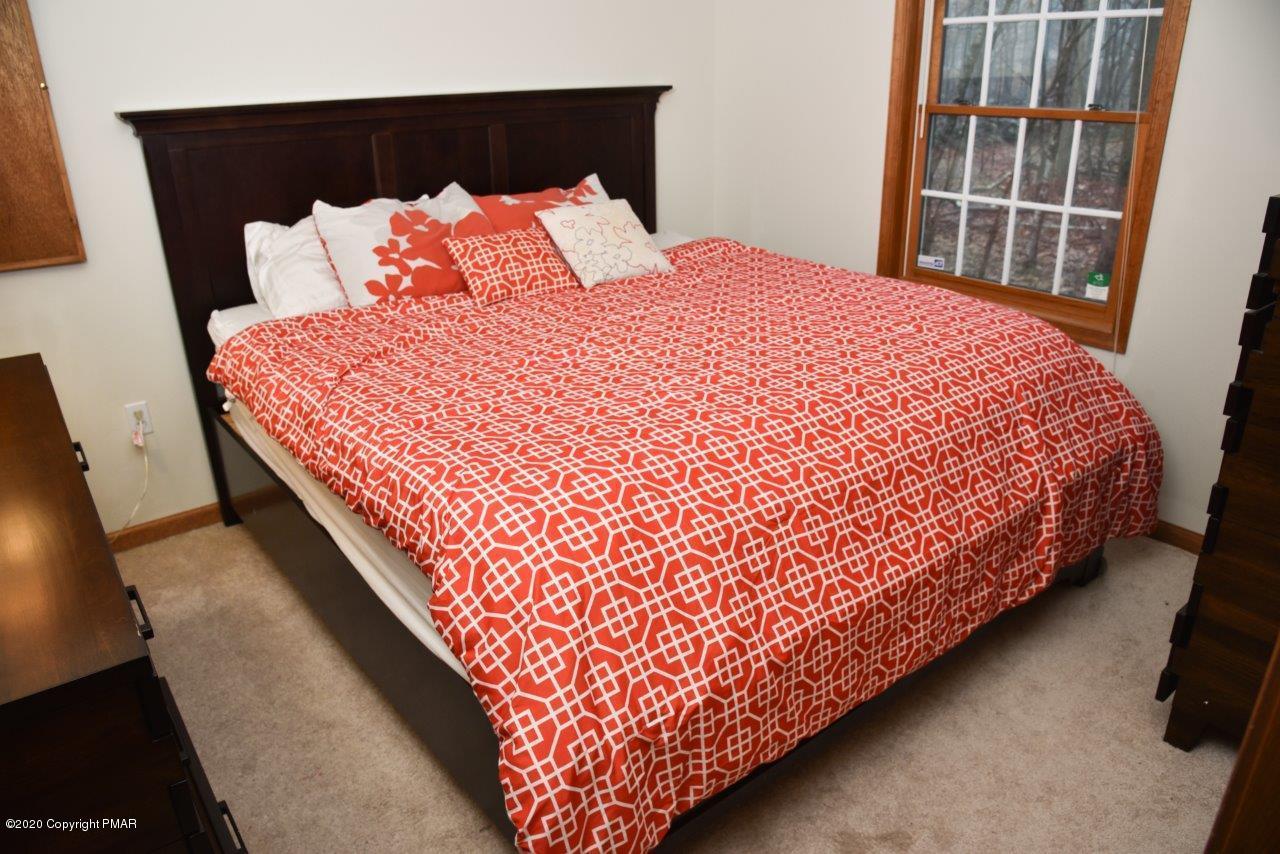 264 Kirkham Road Bushkill, PA 18324 - Photo 11 of 21 a bed sitting in a bedroom next to a large window