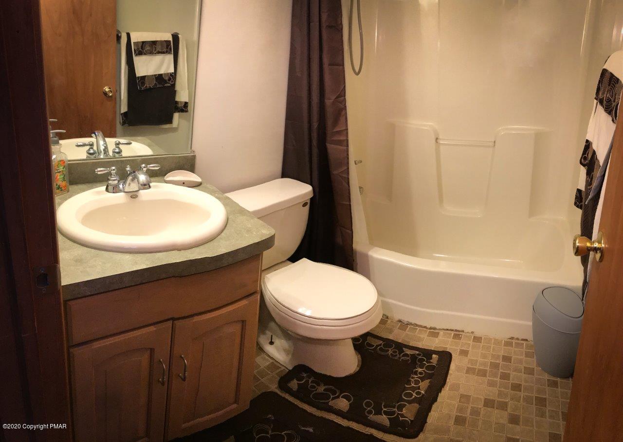264 Kirkham Road Bushkill, PA 18324 - Photo 13 of 21 a bathroom with a sink toilet and shower