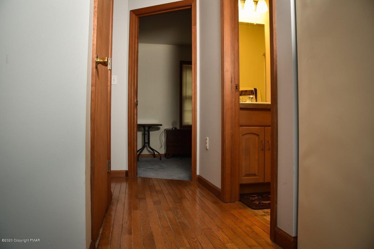 264 Kirkham Road Bushkill, PA 18324 - Photo 14 of 21 a view of a hallway with wooden floor and a bathroom