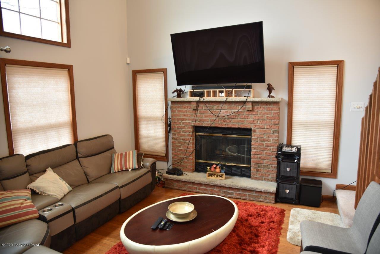 264 Kirkham Road Bushkill, PA 18324 - Photo 4 of 21 a living room with furniture a flat screen tv and a fireplace