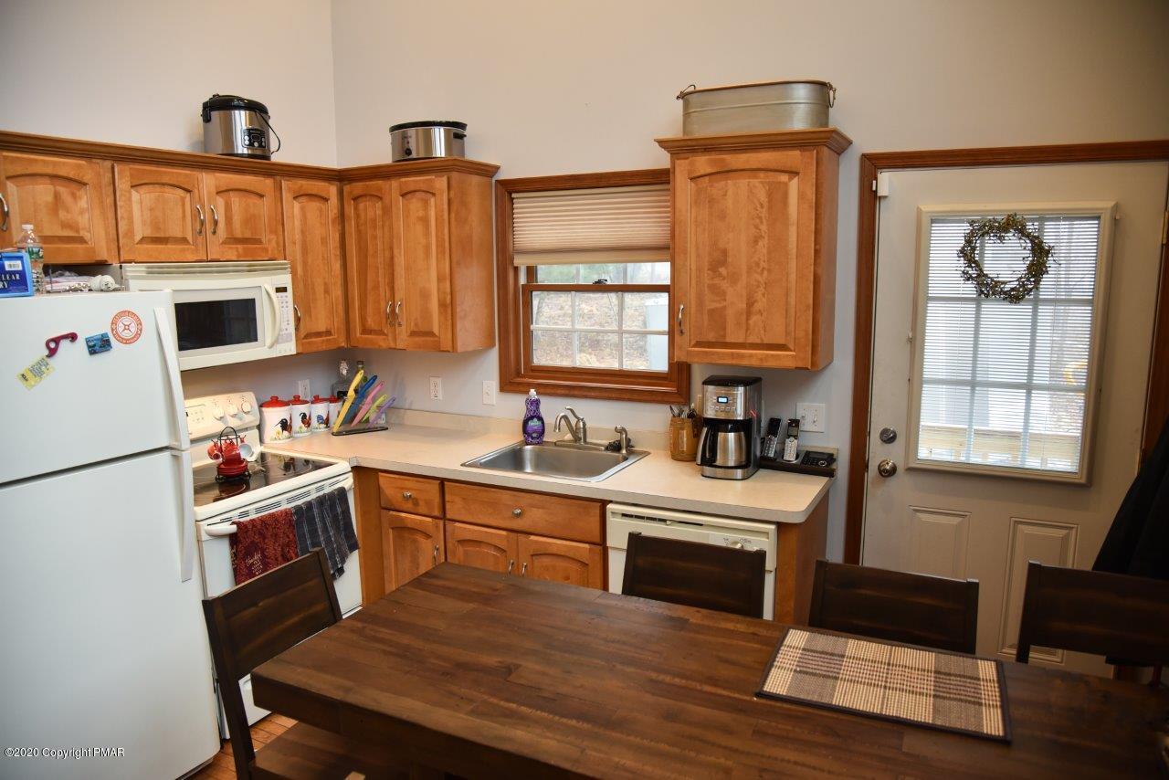 264 Kirkham Road Bushkill, PA 18324 - Photo 10 of 21 a kitchen with stainless steel appliances granite countertop a stove a sink dishwasher and a refrigerator with wooden floor