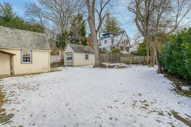 a backyard of a house with a large tree