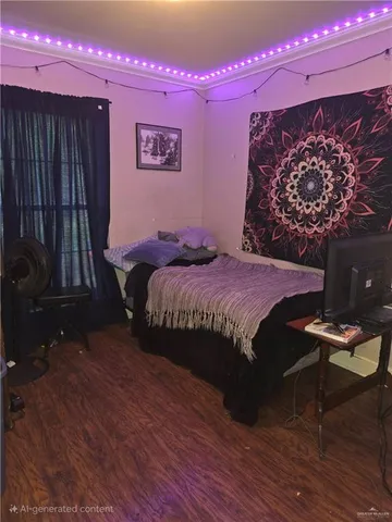 a bedroom with a bed and a dresser with wooden floor