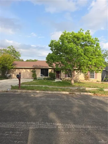 a front view of a house with a yard and a garage