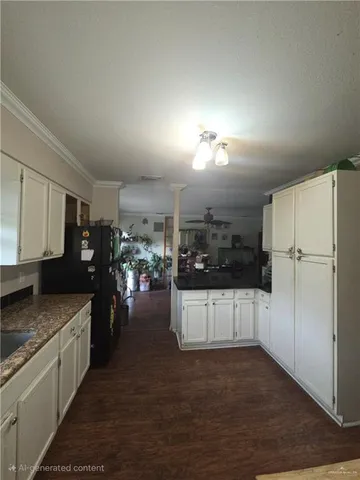 a kitchen with stainless steel appliances granite countertop a refrigerator a stove and a sink
