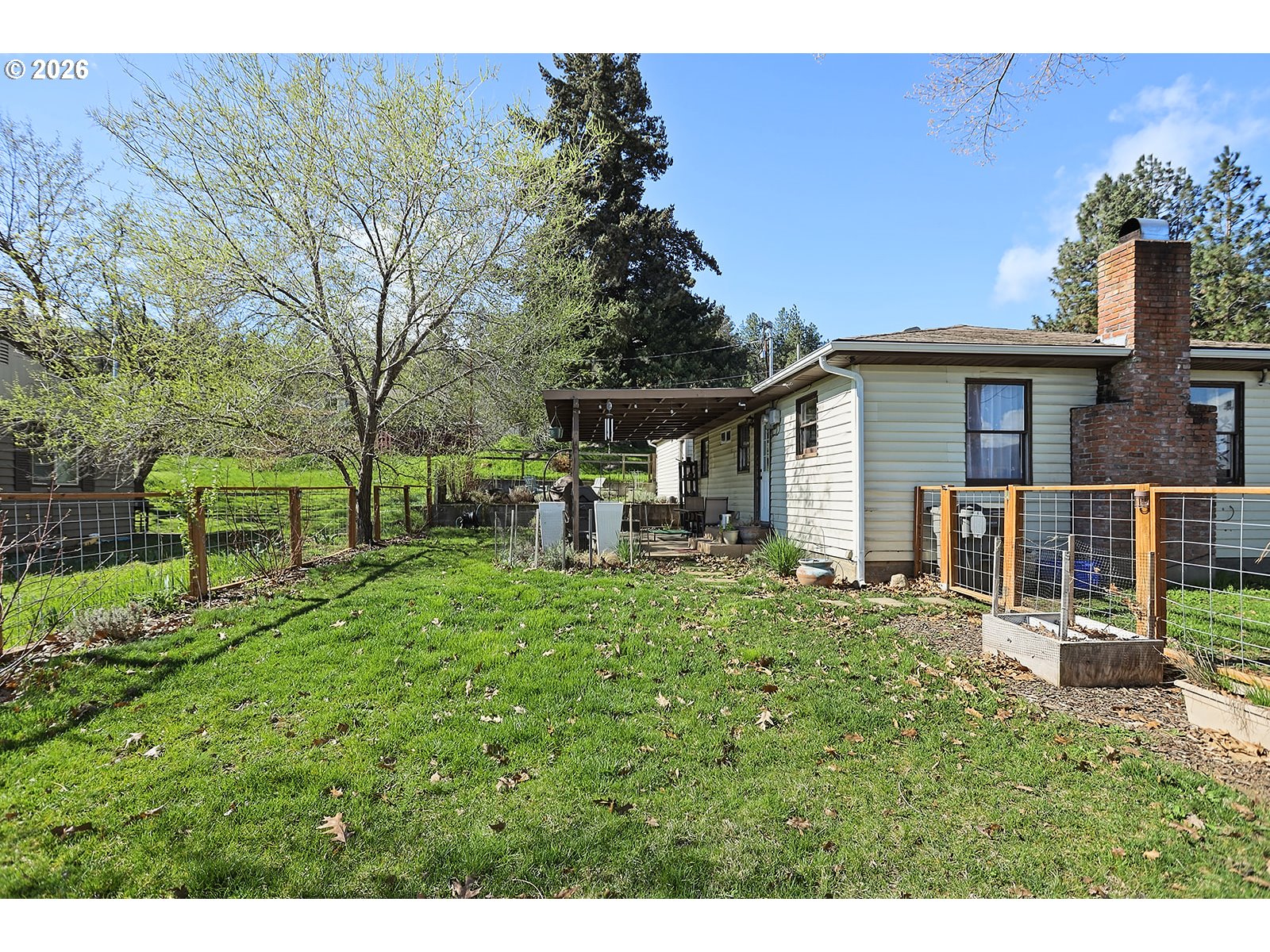 1214 Walnut Street The Dalles, OR 97058 - Photo 28 of 29 a backyard of a house with table and chairs