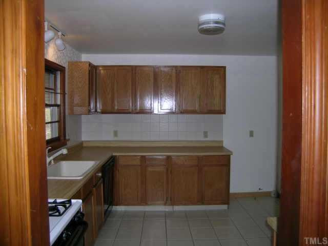 2423 Andor Place Raleigh, NC 27604 - Photo 5 of 6 Nicely remodeled kitchen with ceramic floor, gas stove, porcelain sink, new cabinets and countertops. Other