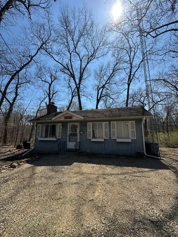 a view of house with a yard