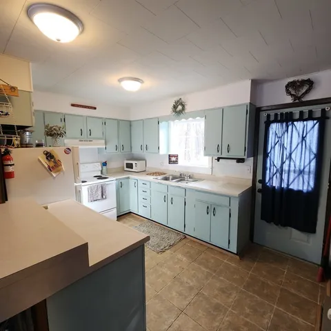 a kitchen with a sink stove and cabinets