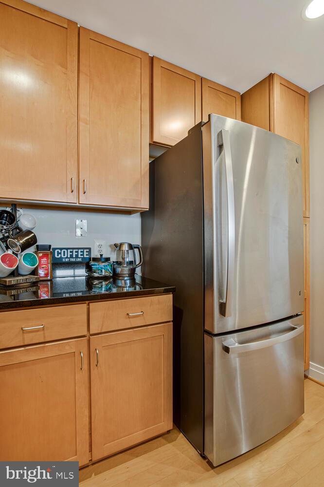 414 Water Street, Unit 2913 Baltimore, MD 21202 - Photo 24 of 41 a kitchen with stainless steel appliances a refrigerator and cabinets