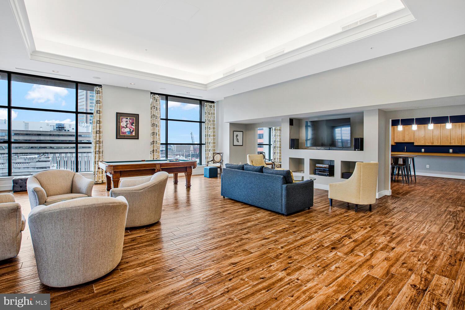 414 Water Street, Unit 2913 Baltimore, MD 21202 - Photo 3 of 41 a living room with furniture wooden floor and a kitchen view