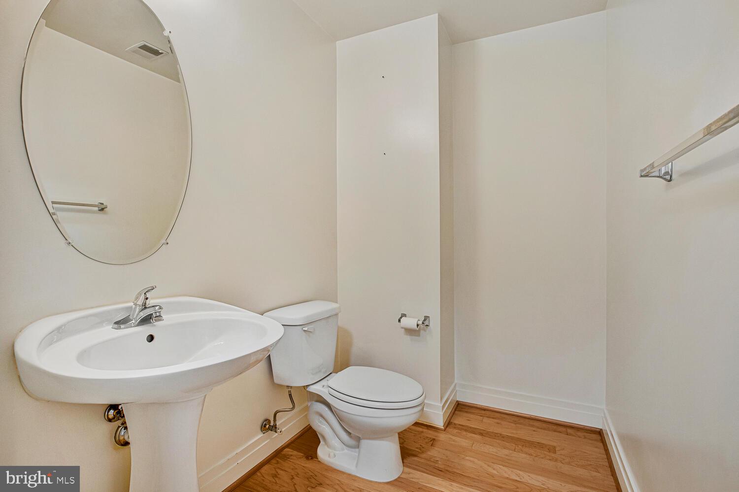 414 Water Street, Unit 2913 Baltimore, MD 21202 - Photo 8 of 41 a bathroom with a sink a toilet and a mirror
