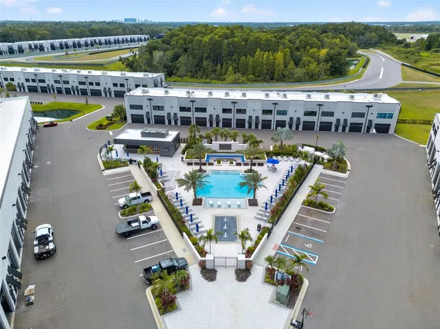 an aerial view of a swimming pool with seating area