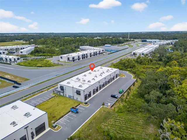 a view of a swimming pool with lawn chairs and plants