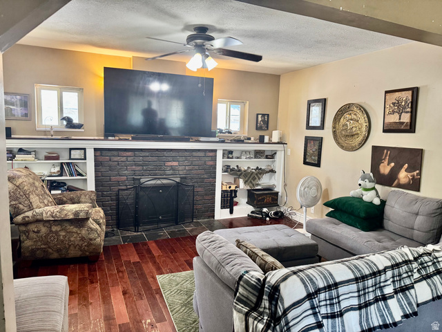 470 East Center Street Logan, UT 84321 - Photo 5 of 16 Living area featuring wood-finish flooring and a brick fireplace