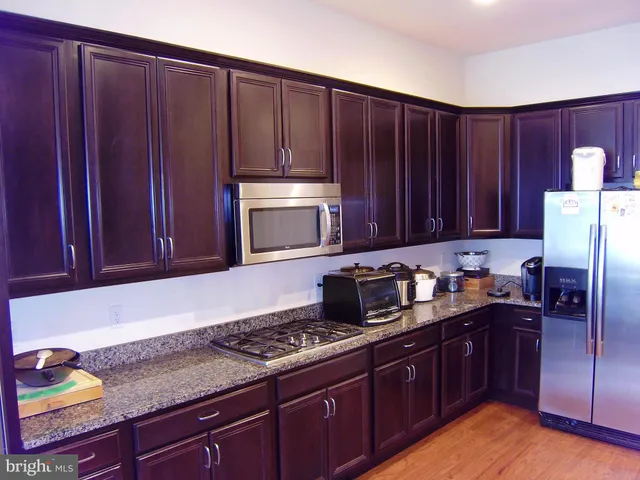a kitchen with sink cabinets and stainless steel appliances