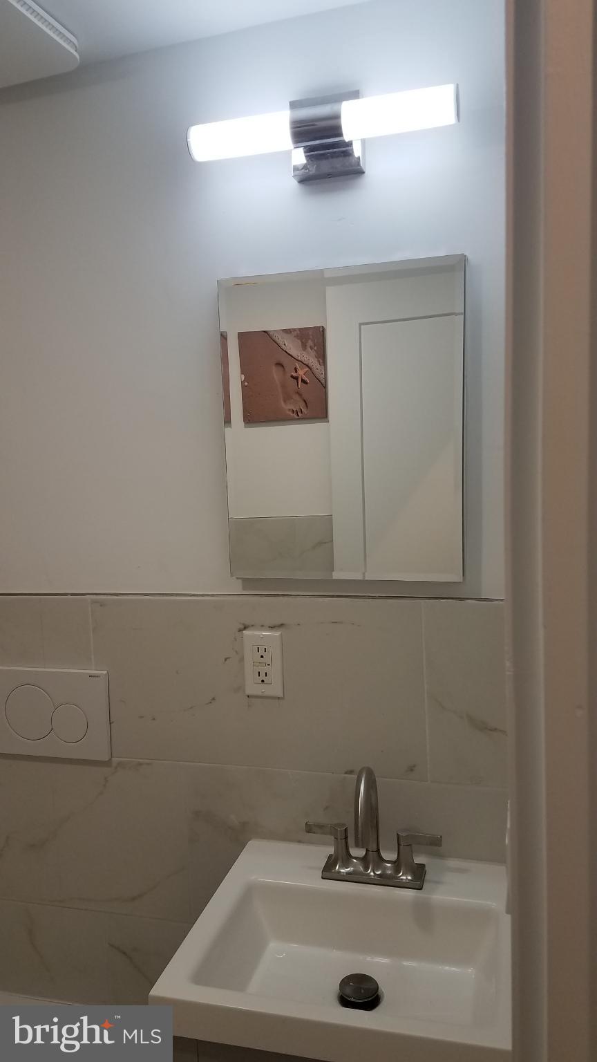 41 Q Street Northwest, Unit B Washington, DC 20001 - Photo 17 of 21 Sleek modern bathroom with elegant fixtures.