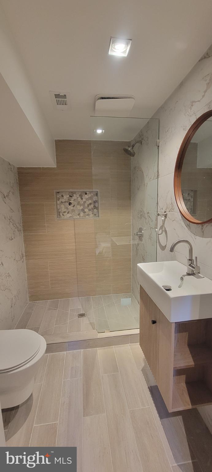 41 Q Street Northwest, Unit B Washington, DC 20001 - Photo 19 of 21 Sleek modern bathroom with elegant finishes.