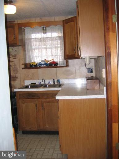 913 Emory Church Road Upperco, MD 21155 - Photo 20 of 30 Laundry room with many cabinets and sink.