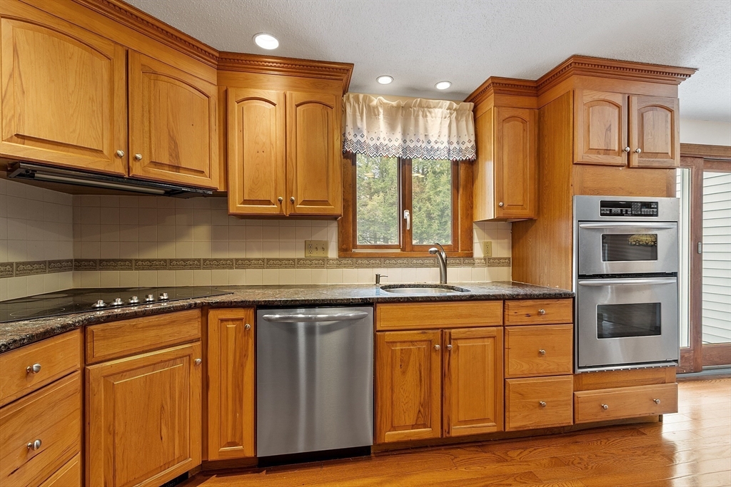 80 A Nashua Road Pepperell, MA 01463 - Photo 3 of 19 a kitchen with stainless steel appliances granite countertop a stove a sink and a microwave