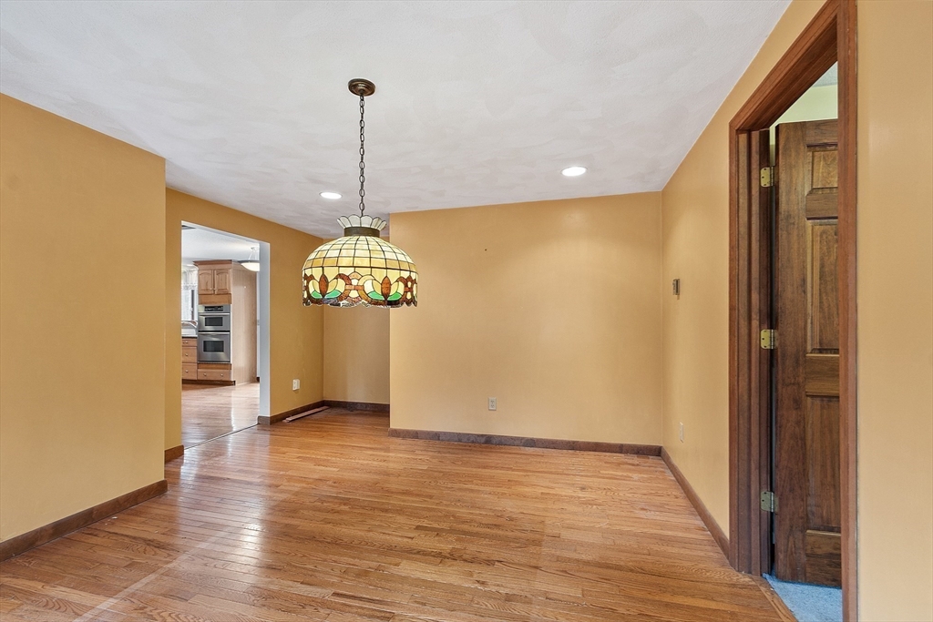 80 A Nashua Road Pepperell, MA 01463 - Photo 8 of 19 a view of a hallway with wooden floor and chandelier
