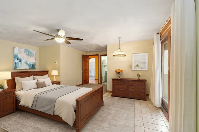 a bedroom with a large bed and a chandelier