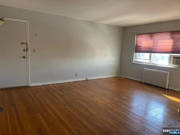 a view of a room with wooden floor and staircase