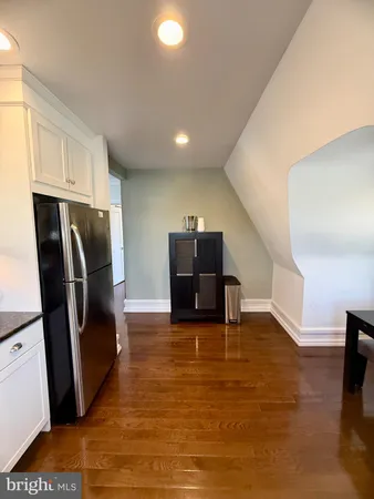 a view of a livingroom with furniture and an empty room