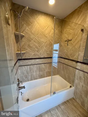 a bathroom with a tub and a shower