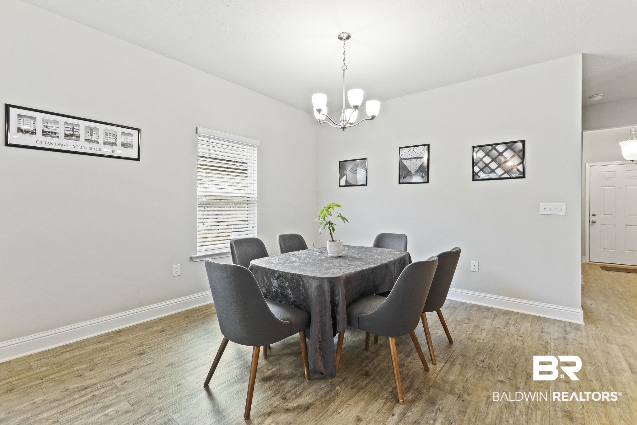 31643 Kestrel Loop Daphne, AL 36527 - Photo 16 of 59 Dining area featuring light wood-type flooring and a notable chandelier