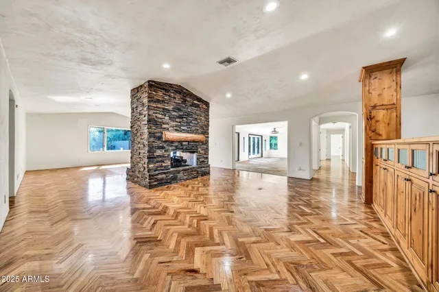 a kitchen with stainless steel appliances granite countertop a stove a sink and a refrigerator