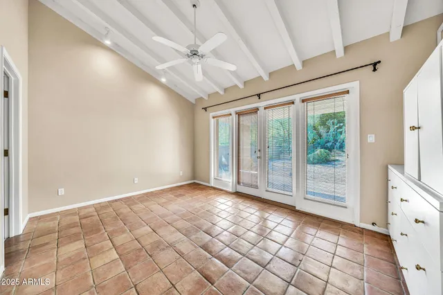 an empty room with a ceiling fan and a ceiling fan