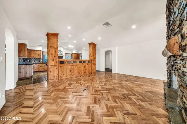 a view of an empty room with floor to ceiling windows
