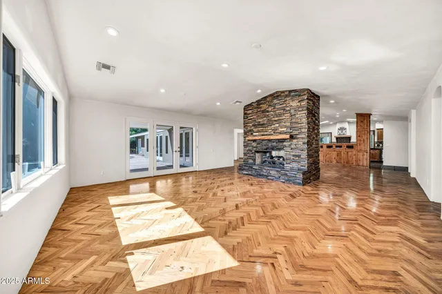 a kitchen with stainless steel appliances granite countertop a stove a sink and a refrigerator