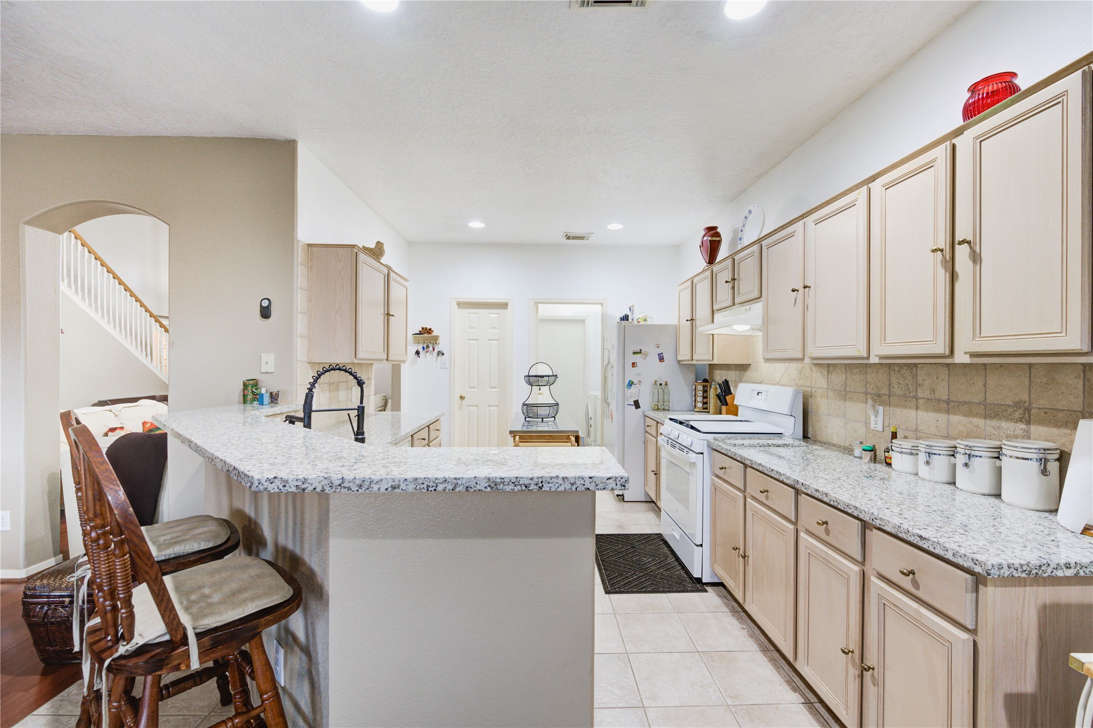 16730 Spring Barker Drive Cypress, TX 77429 - Photo 23 of 50 a kitchen with stainless steel appliances granite countertop a sink and cabinets