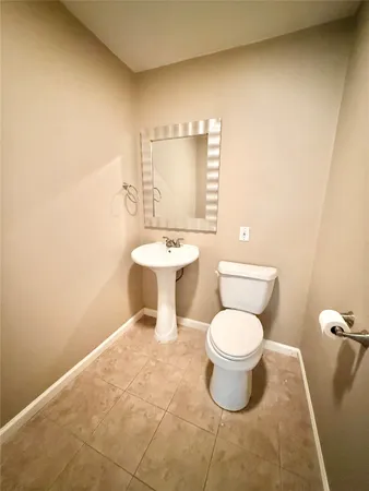 a white toilet sitting next to a bathroom sink
