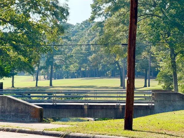 a view of a swimming pool with a lawn chairs and floor to ceiling window