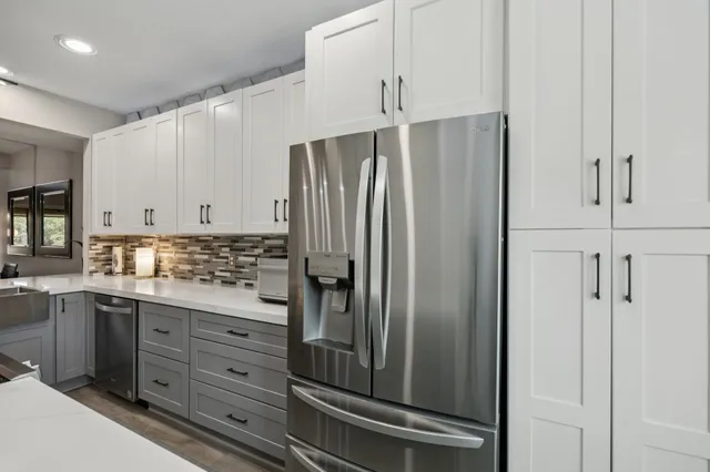 a kitchen that has a stove and a table in it