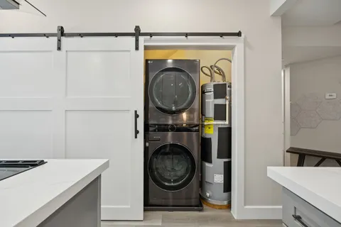 a kitchen with stainless steel appliances cabinets and a table
