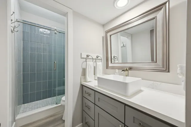 a bathroom with a shower a toilet and a sink