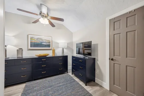 a bedroom with a bed and a lamp on table