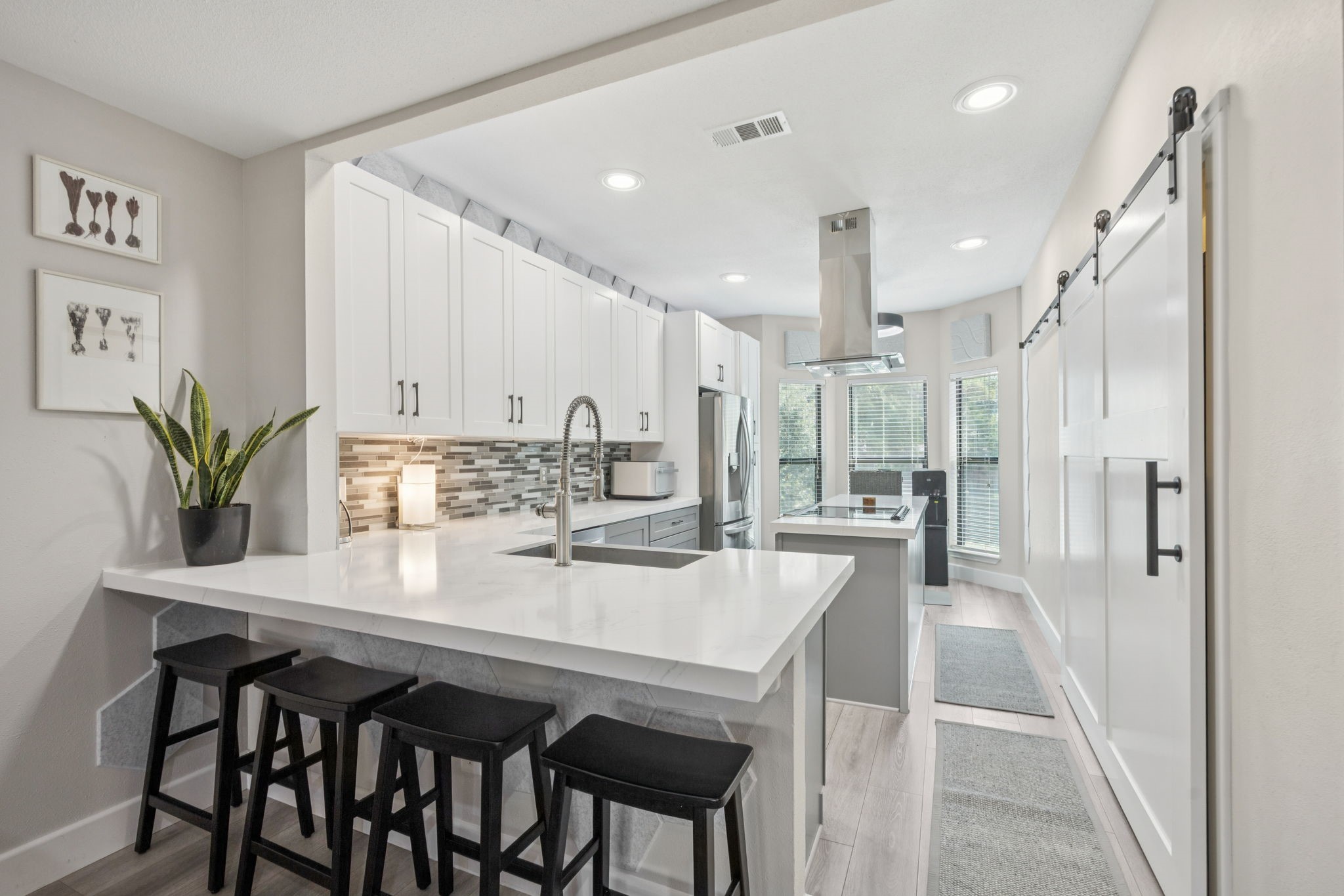 500 River Road, Unit 106 Montgomery, TX 77356 - Photo 9 of 31 a kitchen with kitchen island a table and chairs in it