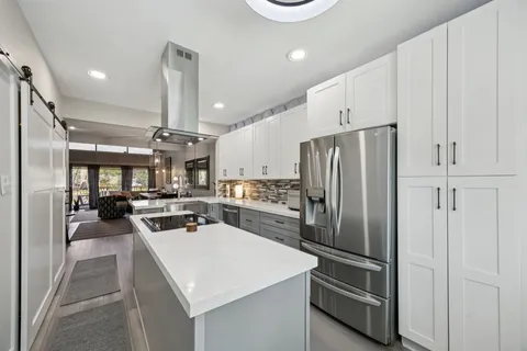 a kitchen with stainless steel appliances a refrigerator and cabinets