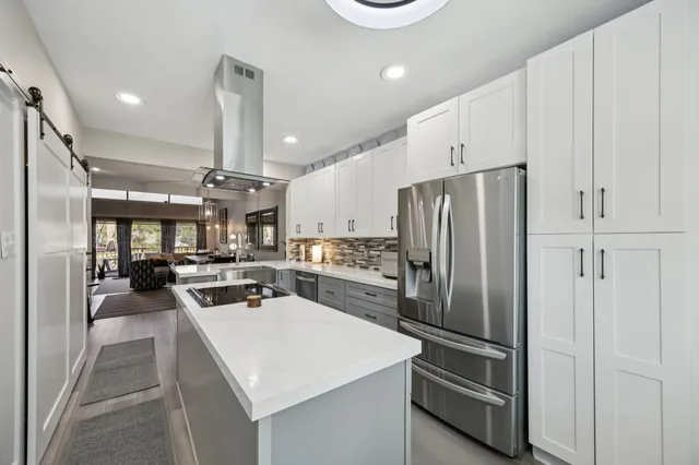 a kitchen with stainless steel appliances a refrigerator and cabinets