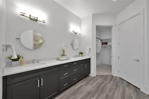 a spacious bathroom with a double vanity sink and a mirror