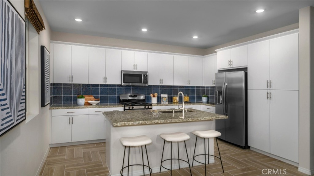 2439 Powell Drive Rialto, CA 92377 - Photo 2 of 17 a kitchen with stainless steel appliances granite countertop a refrigerator a stove top oven a sink and dishwasher