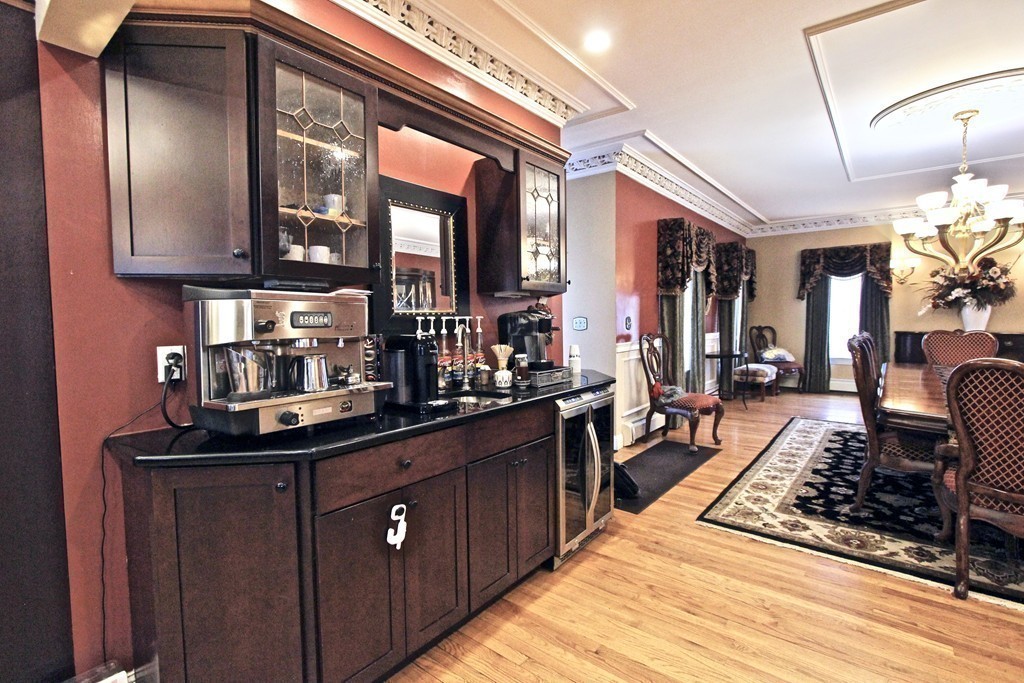 70 Summer Street Stoneham, MA 02180 - Photo 12 of 30 a kitchen with stainless steel appliances granite countertop a sink stove and cabinets