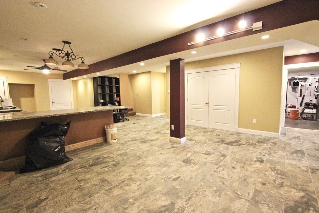 70 Summer Street Stoneham, MA 02180 - Photo 24 of 30 a view of a hallway with furniture and a chandelier